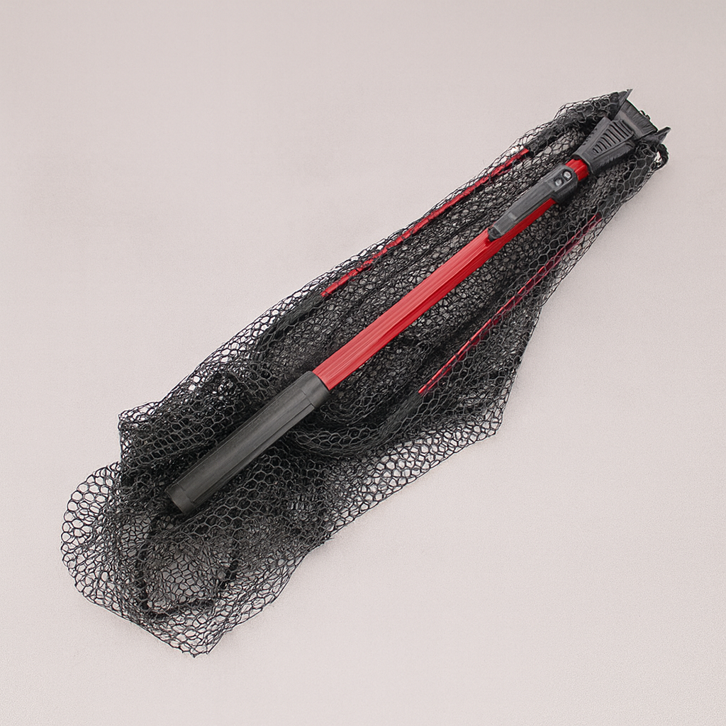 Black and red hair straightener on a black mesh bag against a light gray background