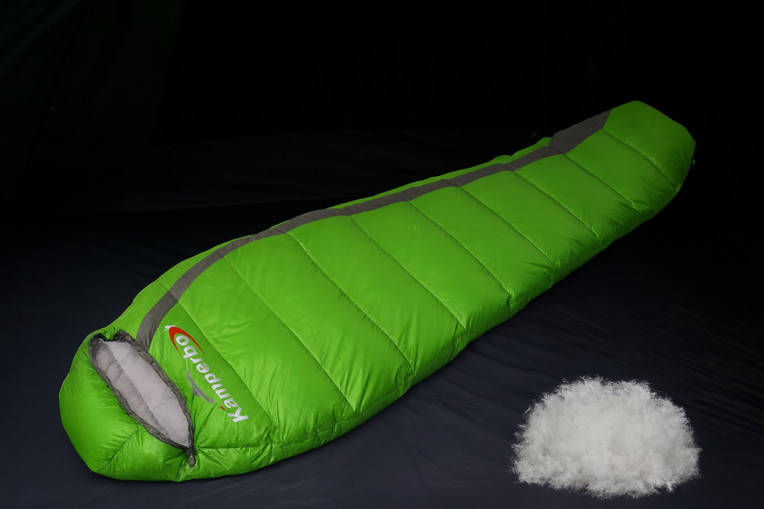 Green sleeping bag with gray accents on a black background